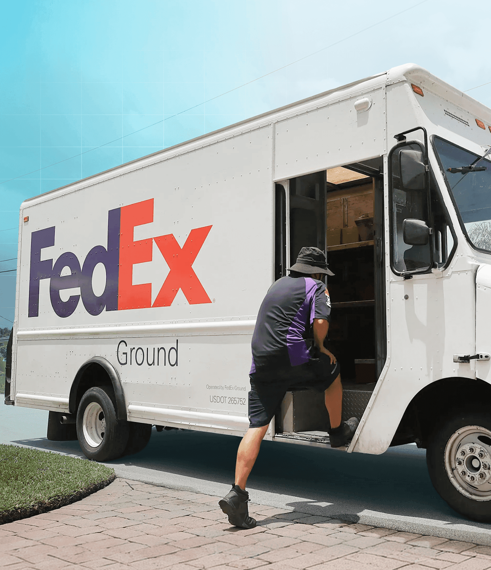 FedEx worker unloading packages from FedEx truck.
