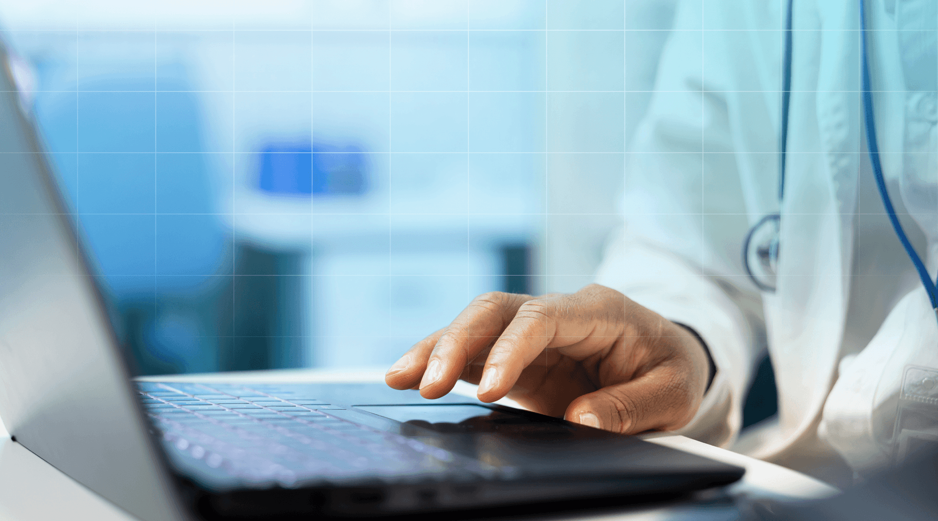 Doctor researching insurance on a laptop.