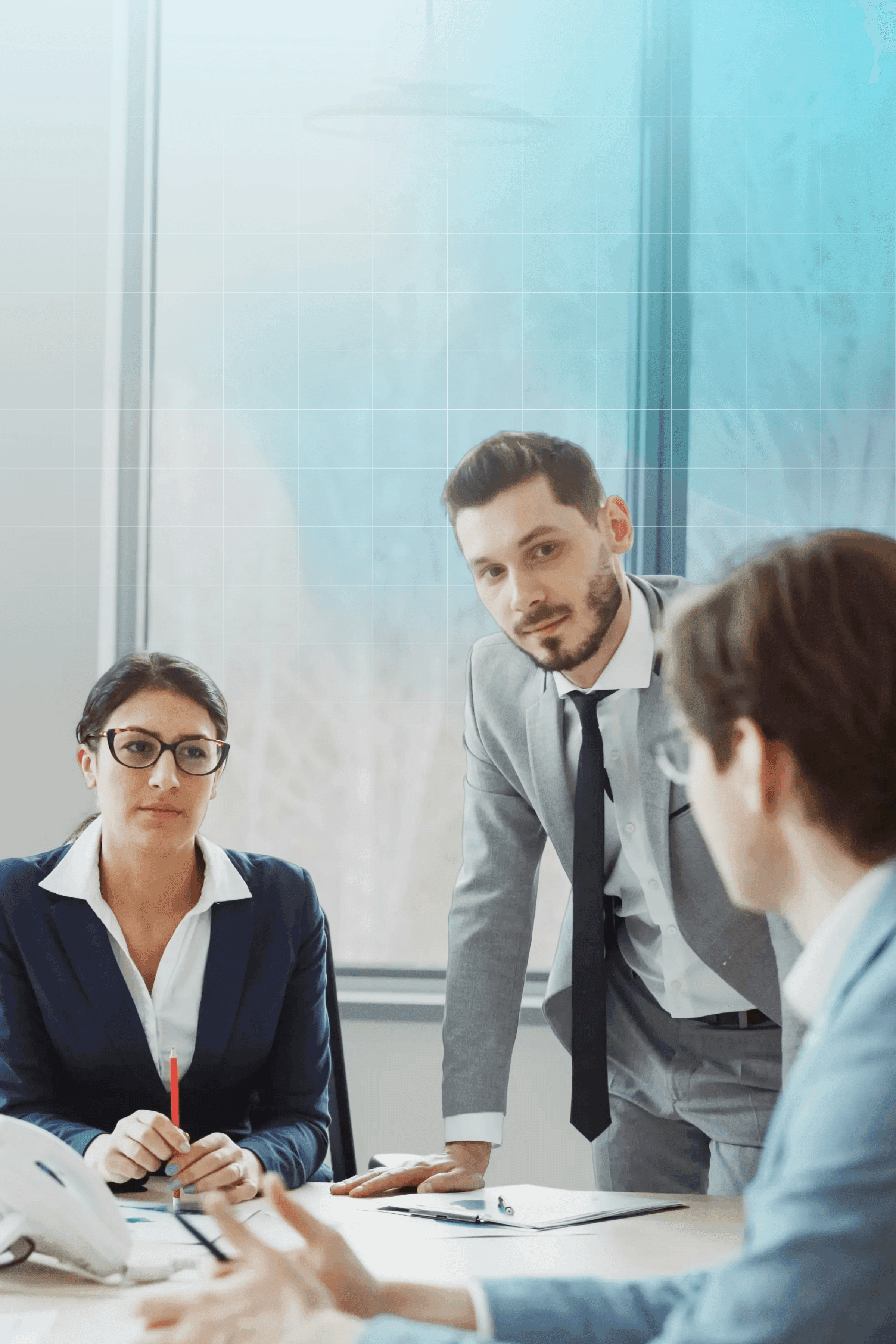 Professionals discussing liability insurance at a table.